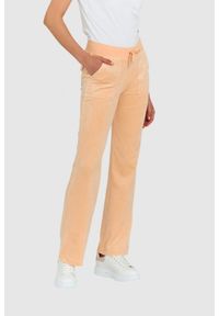 Juicy Couture - JUICY COUTURE Klasyczne welurowe spodnie dresowe del ray w brzoskwiniowym kolorze. Kolor: pomarańczowy. Materiał: dresówka, welur