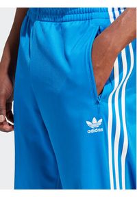 Adidas - adidas Spodnie dresowe adicolor Classics Firebird IJ7056 Niebieski Regular Fit. Kolor: niebieski. Materiał: syntetyk