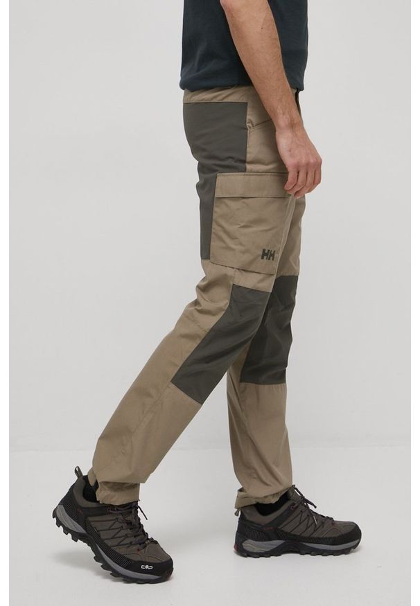 Helly Hansen spodnie outdoorowe Vandre męskie kolor beżowy. Kolor: beżowy. Materiał: bawełna, materiał, softshell, poliester, włókno
