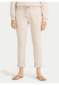 Kremowe bawełniane spodnie dresowe Juvia. Kolor: kremowy. Materiał: dresówka, bawełna #1