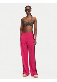 Adidas - adidas Spodnie dresowe Firebird Loose Tracksuit KW0228 Różowy Loose Fit. Kolor: różowy. Materiał: syntetyk #5