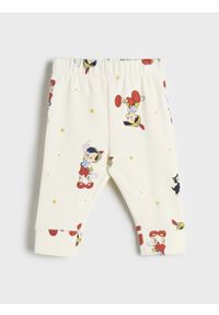 Sinsay - Legginsy Disney - kremowy. Kolor: kremowy. Materiał: elastan, bawełna. Wzór: motyw z bajki