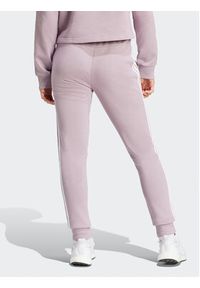 Adidas - adidas Spodnie dresowe Essentials 3-Stripes IR5379 Różowy Slim Fit. Kolor: różowy. Materiał: bawełna #5