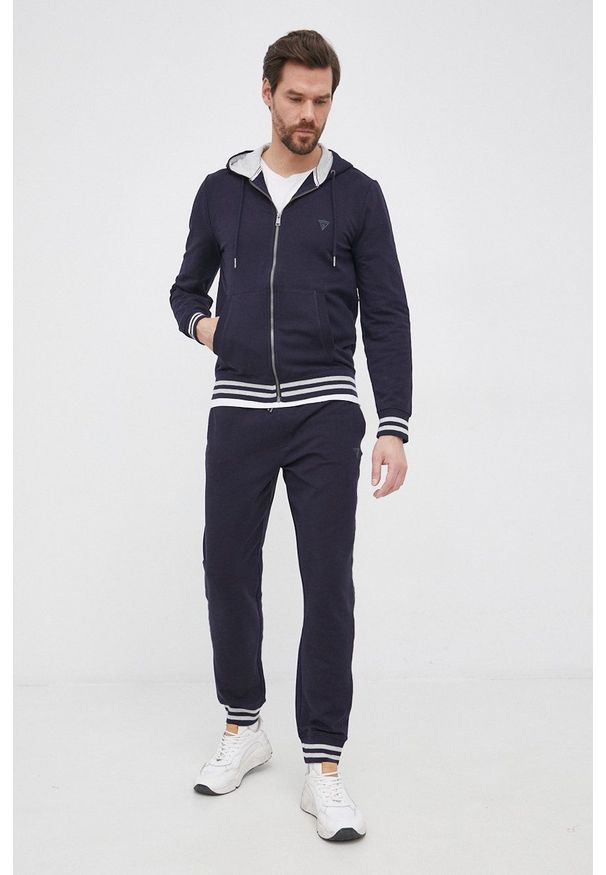 Guess Bluza męska kolor granatowy z kapturem gładka. Okazja: na co dzień. Typ kołnierza: kaptur. Kolor: niebieski. Materiał: bawełna, dzianina. Wzór: gładki. Styl: casual