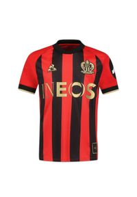 Le Coq Sportif - Koszulka domowa dla dzieci OGC Nice 2024/25. Kolor: czerwony, czarny, wielokolorowy. Sezon: lato. Sport: piłka nożna