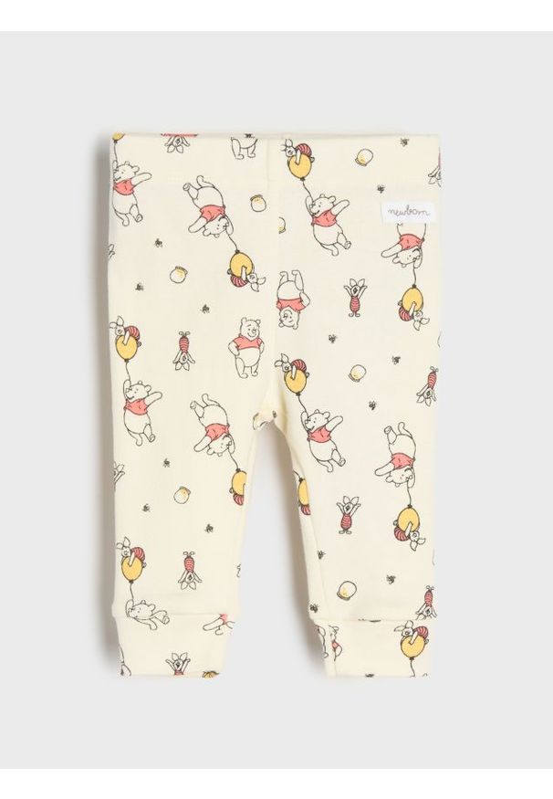 Sinsay - Bawełniane legginsy ze wzorem Winnie the Pooh - beżowy. Kolor: beżowy. Materiał: bawełna