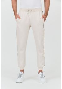 Guess - GUESS Beżowe spodnie Mickey Cuff Pant. Kolor: beżowy