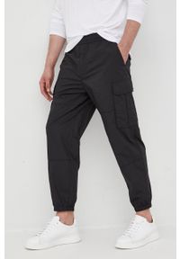 Armani Exchange spodnie dresowe bawełniane męskie kolor czarny gładkie. Kolor: czarny. Materiał: dresówka, bawełna. Wzór: gładki