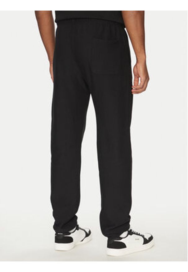 Champion Spodnie dresowe 221620 Czarny Regular Fit. Kolor: czarny. Materiał: bawełna