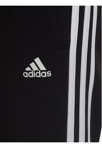 Adidas - adidas Spodnie dresowe adidas Essential 3-Stripes Joggers H65796 Czarny Regular Fit. Kolor: czarny. Materiał: bawełna #2