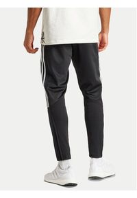 Adidas - adidas Spodnie dresowe Tiro IP3778 Czarny Regular Fit. Kolor: czarny. Materiał: bawełna