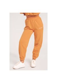 GYM GLAMOUR - Spodnie fitness damskie Gym Glamour dresowe. Kolor: pomarańczowy. Materiał: dresówka. Sport: fitness #1