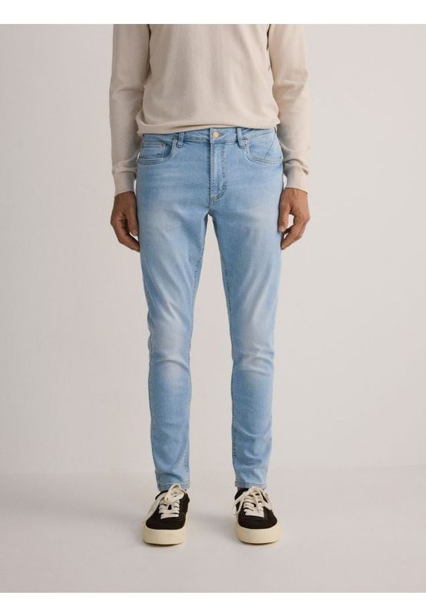 Reserved - Jeansy skinny z efektem sprania - niebieski. Kolor: niebieski