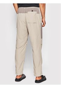 New Balance Spodnie materiałowe MP21502 Beżowy Relaxed Fit. Kolor: beżowy. Materiał: syntetyk, materiał
