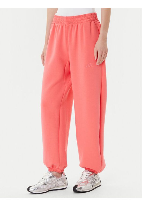 Adidas - adidas Spodnie dresowe ALL SZN Soft Lux lKD9773 Koralowy Loose Fit. Kolor: pomarańczowy. Materiał: syntetyk