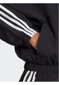 Adidas - adidas Wiatrówka Essentials 3-Stripes Woven Windbreaker HT3399 Czarny Loose Fit. Kolor: czarny. Materiał: syntetyk