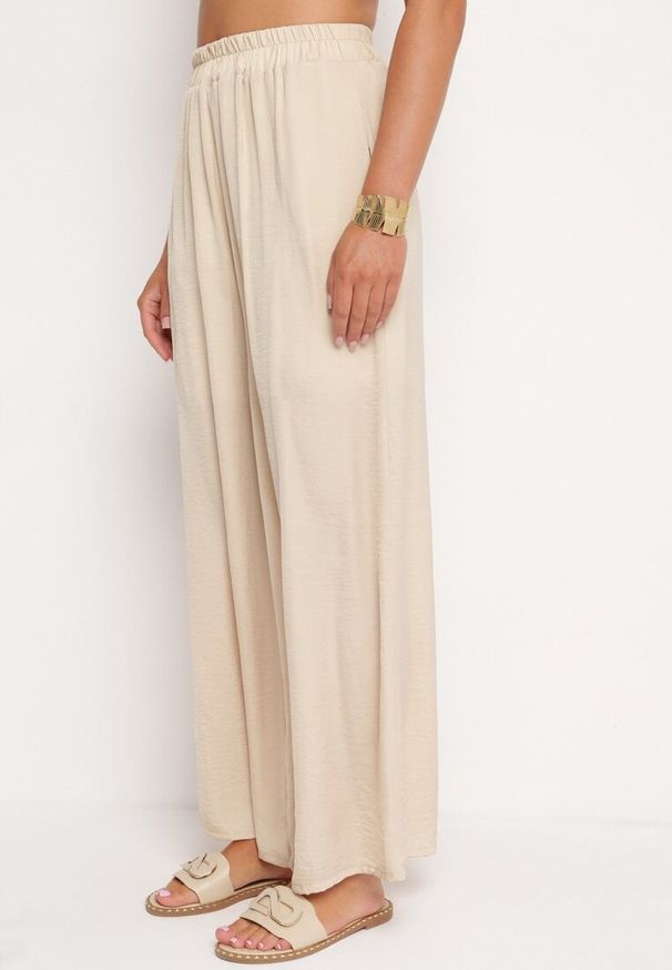 Born2be - Beżowe Szerokie Spodnie z Wiskozy z Wysokim Stanem Rissalie. Okazja: na co dzień. Stan: podwyższony. Kolor: beżowy. Materiał: wiskoza. Długość: długie. Styl: klasyczny, casual, elegancki