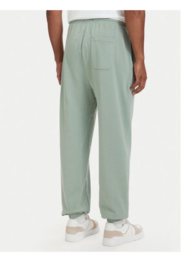 TOMMY HILFIGER - Tommy Hilfiger Spodnie dresowe Essential UM0UM03911 Zielony jasny Relaxed Fit. Kolor: zielony. Materiał: bawełna