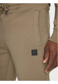 Hugo - HUGO Spodnie dresowe Dimacs 50533695 Brązowy Relaxed Fit. Kolor: brązowy. Materiał: bawełna