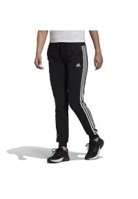 Adidas - Spodnie dresowe adidas Essentials Single Jersey 3-Stripes Pants GM5542 - czarne. Kolor: czarny. Materiał: jersey, dresówka. Wzór: aplikacja