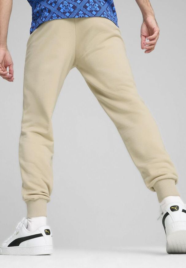 Puma - Męskie spodnie dresowe ftblCULTURE Olympique Marsylia PUMA. Kolor: wielokolorowy, beżowy, niebieski. Materiał: dresówka