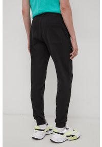 Tommy Jeans Spodnie męskie kolor czarny gładkie. Kolor: czarny. Materiał: bawełna, dzianina. Wzór: gładki