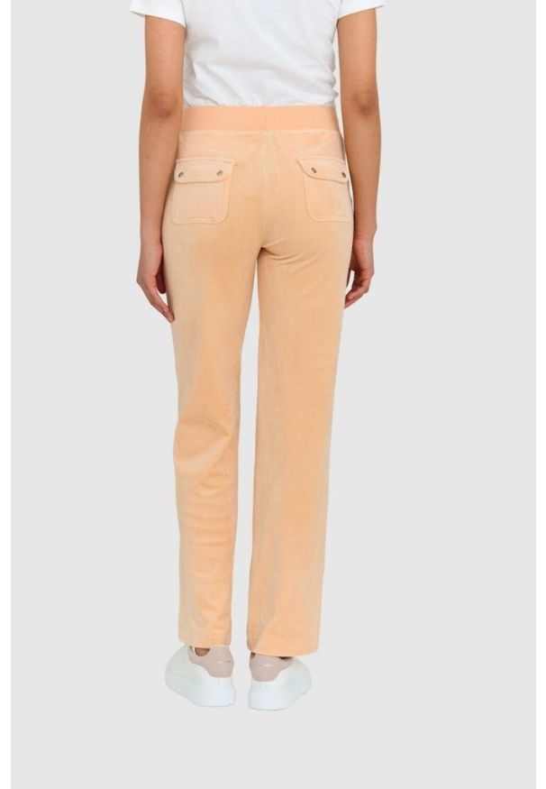 Juicy Couture - JUICY COUTURE Klasyczne welurowe spodnie dresowe del ray w brzoskwiniowym kolorze. Kolor: pomarańczowy. Materiał: welur, dresówka