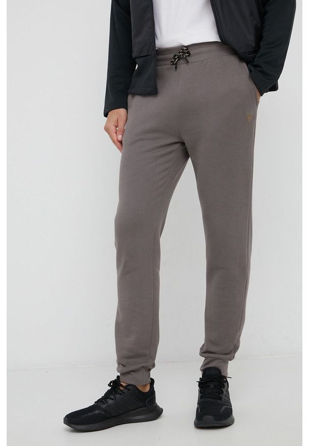 Guess Spodnie bawełniane męskie kolor szary gładkie. Kolor: szary. Materiał: bawełna. Wzór: gładki