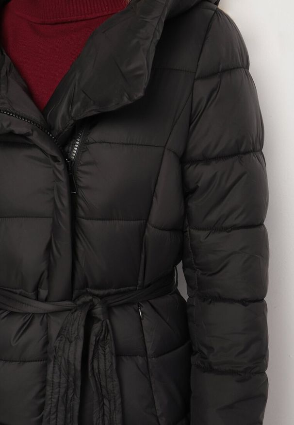 Born2be - Czarna Pikowana Kurtka o Długim Kroju z Paskiem i Futrzaną Wyściółką Fivlemi. Okazja: na co dzień. Kolor: czarny. Materiał: futro. Długość: długie. Sezon: zima. Styl: casual, elegancki