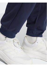 Adidas - adidas Spodnie dresowe Future Icons Allover Print IJ8853 Granatowy Regular Fit. Kolor: niebieski. Materiał: syntetyk. Wzór: nadruk
