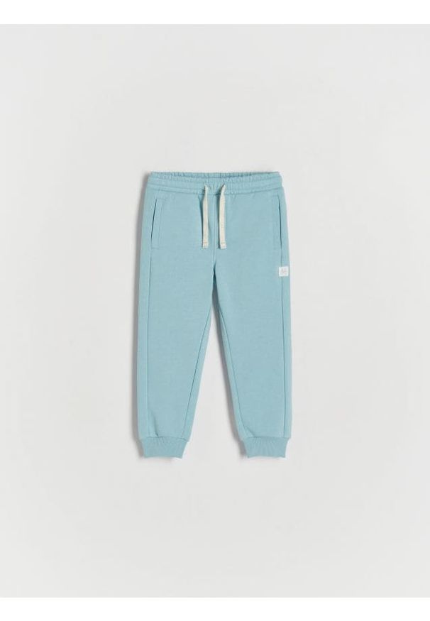 Reserved - Spodnie jogger - niebieski. Kolor: niebieski. Materiał: bawełna, dzianina