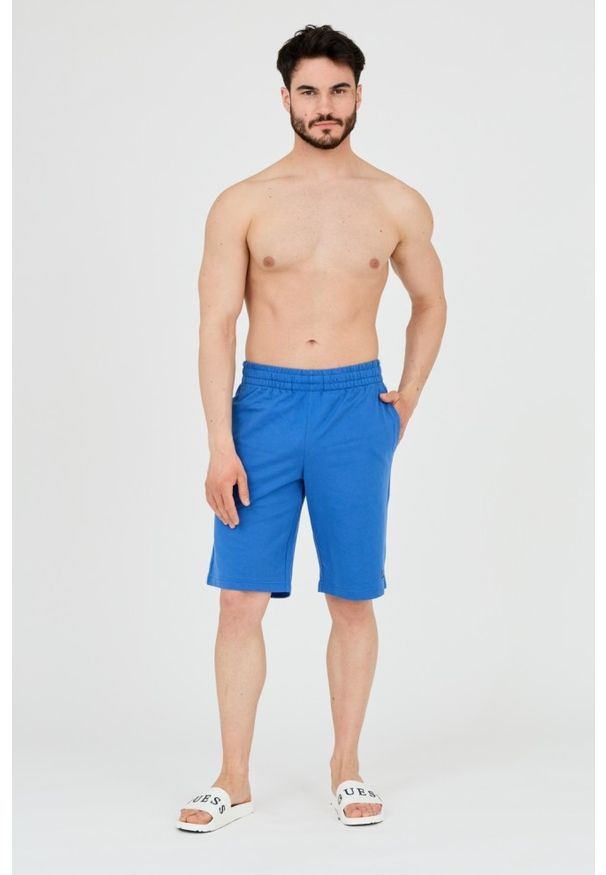 EA7 Emporio Armani - EA7 Niebieskie shorty męskie z małym logo. Kolor: niebieski. Materiał: bawełna. Długość: krótkie