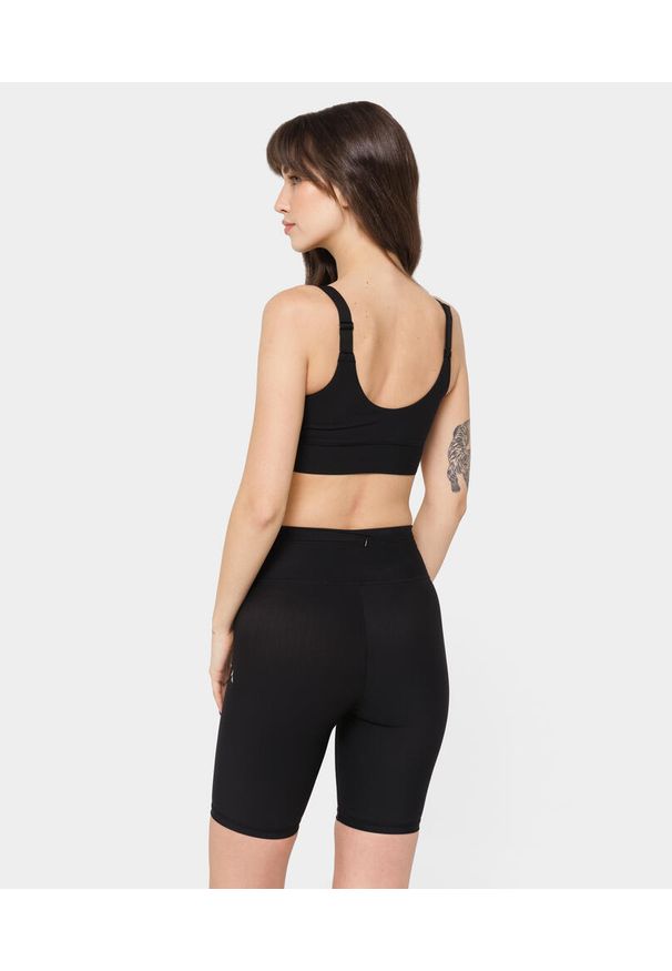 Biustonosz sportowy dla kobiet Carpatree Onyx Flow z regulowanymi ramiączkami. Kolor: czarny. Sport: fitness, bieganie