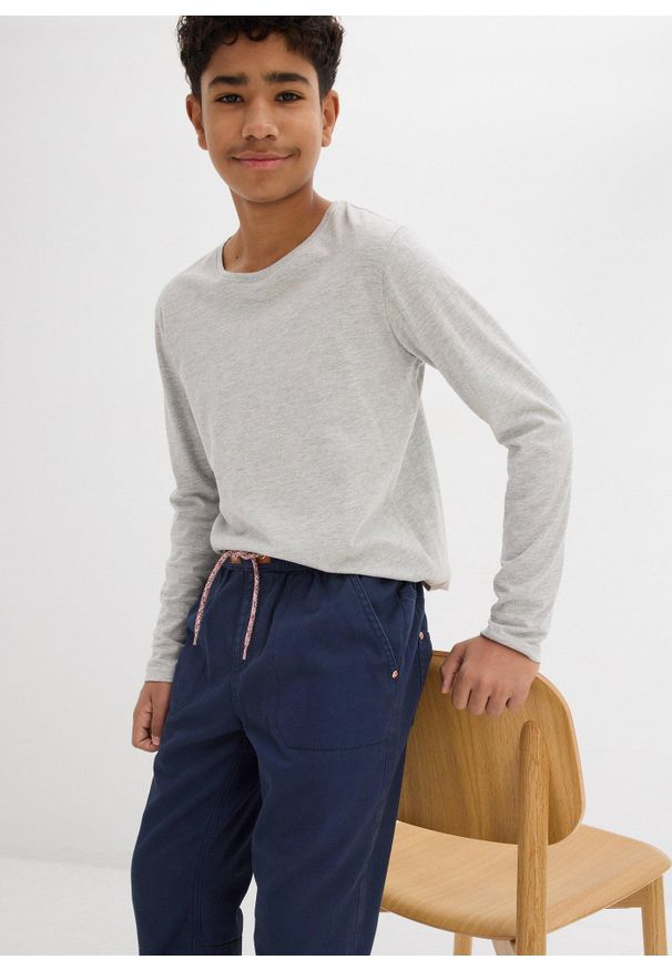 bonprix - Spodnie chłopięce ocieplane z podszewką z dżerseju, regular fit. Kolor: niebieski. Materiał: jersey. Styl: sportowy