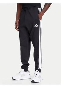 Adidas - adidas Spodnie dresowe Essentials 3-Stripes JD1861 Czarny Regular Fit. Kolor: czarny. Materiał: bawełna
