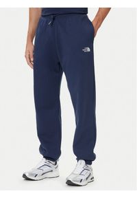 The North Face Spodnie dresowe Essential NF0A8C1F Granatowy Relaxed Fit. Kolor: niebieski. Materiał: syntetyk
