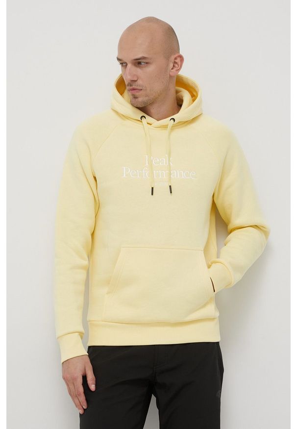 Peak Performance bluza męska kolor żółty z kapturem z aplikacją. Okazja: na co dzień. Typ kołnierza: kaptur. Kolor: żółty. Materiał: bawełna, dzianina. Długość rękawa: raglanowy rękaw. Wzór: aplikacja. Styl: casual