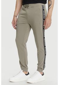 Guess - GUESS Zielone męskie spodnie dresowe z lampasami New Arlo, Rozmiar S. Kolor: zielony. Materiał: dresówka #1