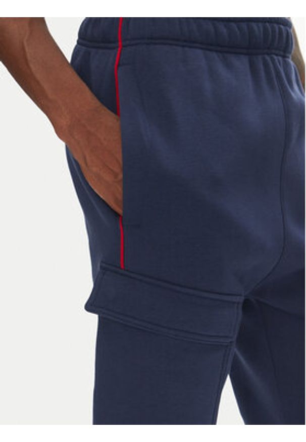 Nike Spodnie dresowe HM0180 Granatowy Regular Fit. Kolor: niebieski. Materiał: bawełna
