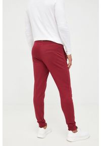 TOMMY HILFIGER - Tommy Hilfiger spodnie dresowe męskie kolor bordowy gładkie. Kolor: czerwony. Materiał: dresówka. Wzór: gładki #4