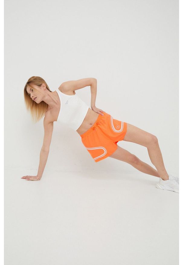 Adidas by Stella McCartney - adidas by Stella McCartney szorty do biegania Truepace HB6080 damskie kolor pomarańczowy z nadrukiem medium waist. Kolor: pomarańczowy. Materiał: dzianina, materiał. Wzór: nadruk