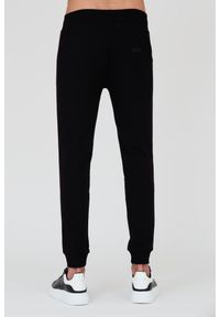 MOSCHINO Czarne męskie spodnie dresowe z lampasami, Rozmiar L. Kolor: czarny. Materiał: dresówka #7