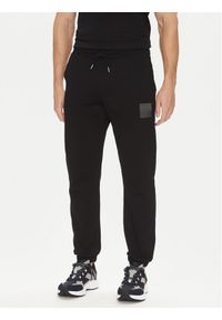 Hugo - HUGO Spodnie dresowe Dusplitan 50542866 Czarny Relaxed Fit. Kolor: czarny. Materiał: bawełna