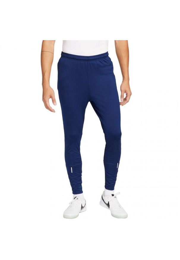 Nike - Męskie Spodnie Do Biegania ThermaFit Strike. Kolor: niebieski