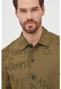 Calvin Klein Jeans koszula bawełniana męska kolor zielony relaxed z kołnierzykiem klasycznym. Typ kołnierza: kołnierzyk klasyczny. Kolor: zielony. Materiał: bawełna. Długość rękawa: krótki rękaw. Długość: krótkie. Styl: klasyczny