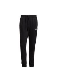 Adidas - Spodnie męskie adidas Essentials Tapered Cuff 3 Stripes. Kolor: wielokolorowy, biały, czarny. Materiał: bawełna, poliester, wiskoza. Wzór: paski. Sport: joga i pilates