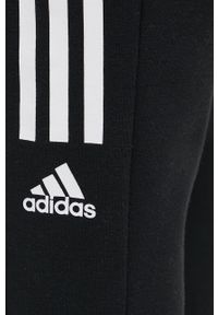 Adidas - adidas spodnie damskie kolor czarny z nadrukiem. Kolor: czarny. Wzór: nadruk