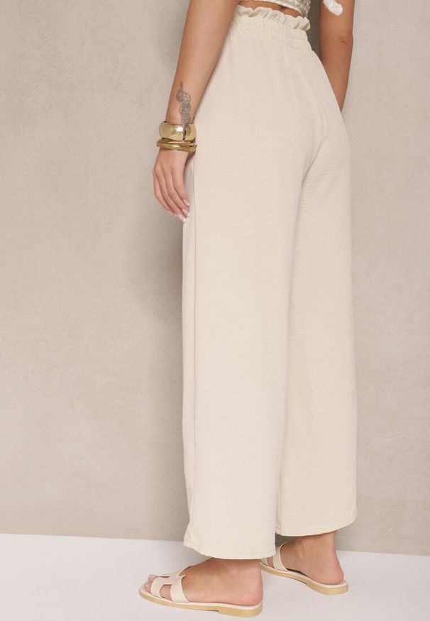Renee - Beżowe Spodnie z Wiskozą o Szerokim Kroju High Waist z Wiązaniem Ivelwia. Stan: podwyższony. Kolor: beżowy. Materiał: wiskoza. Sezon: lato