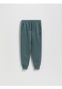 Reserved - Bawełniane joggery z meszkiem - zielony. Kolor: zielony. Materiał: bawełna