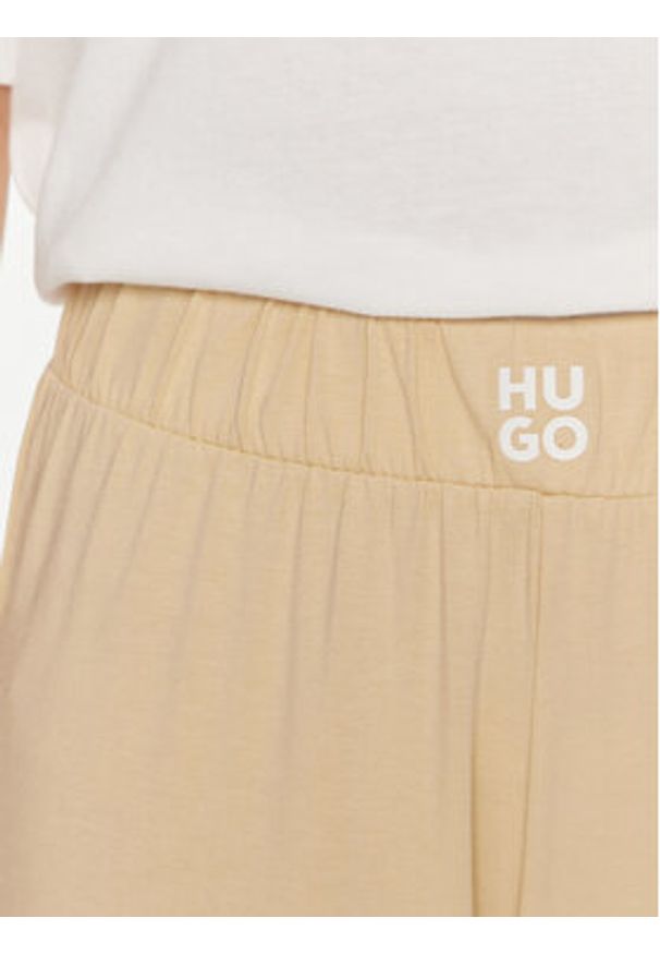 Hugo Spodnie materiałowe 50514874 Beżowy Regular Fit. Kolor: beżowy. Materiał: bawełna, lyocell